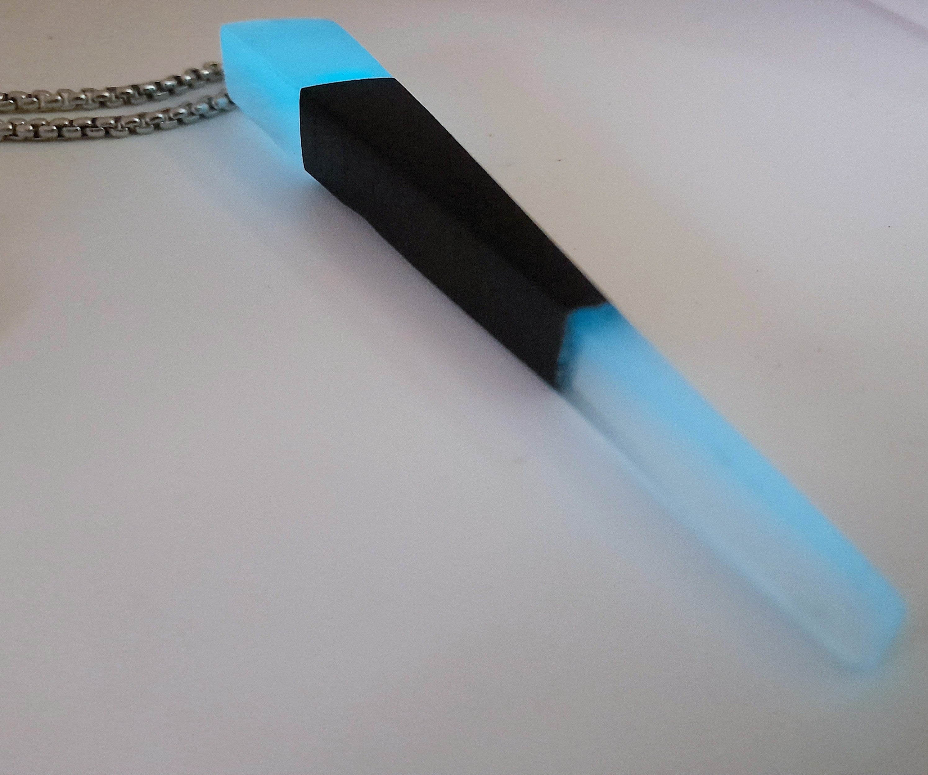 Handmade Irish Bog Oak Dagger Pendant – Glow-in-the-Dark Cyan Resin | Titanium Plated Chain