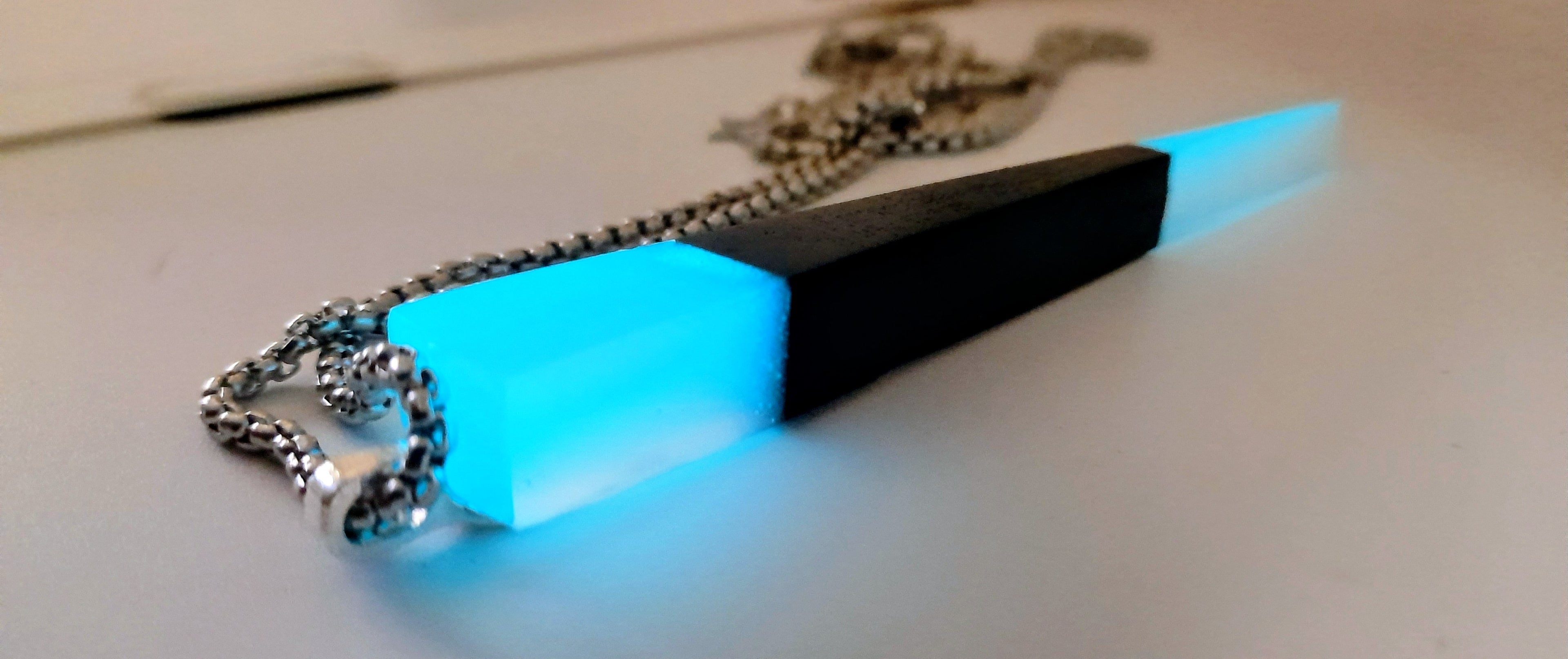 Handmade Irish Bog Oak Dagger Pendant – Glow-in-the-Dark Cyan Resin | Titanium Plated Chain