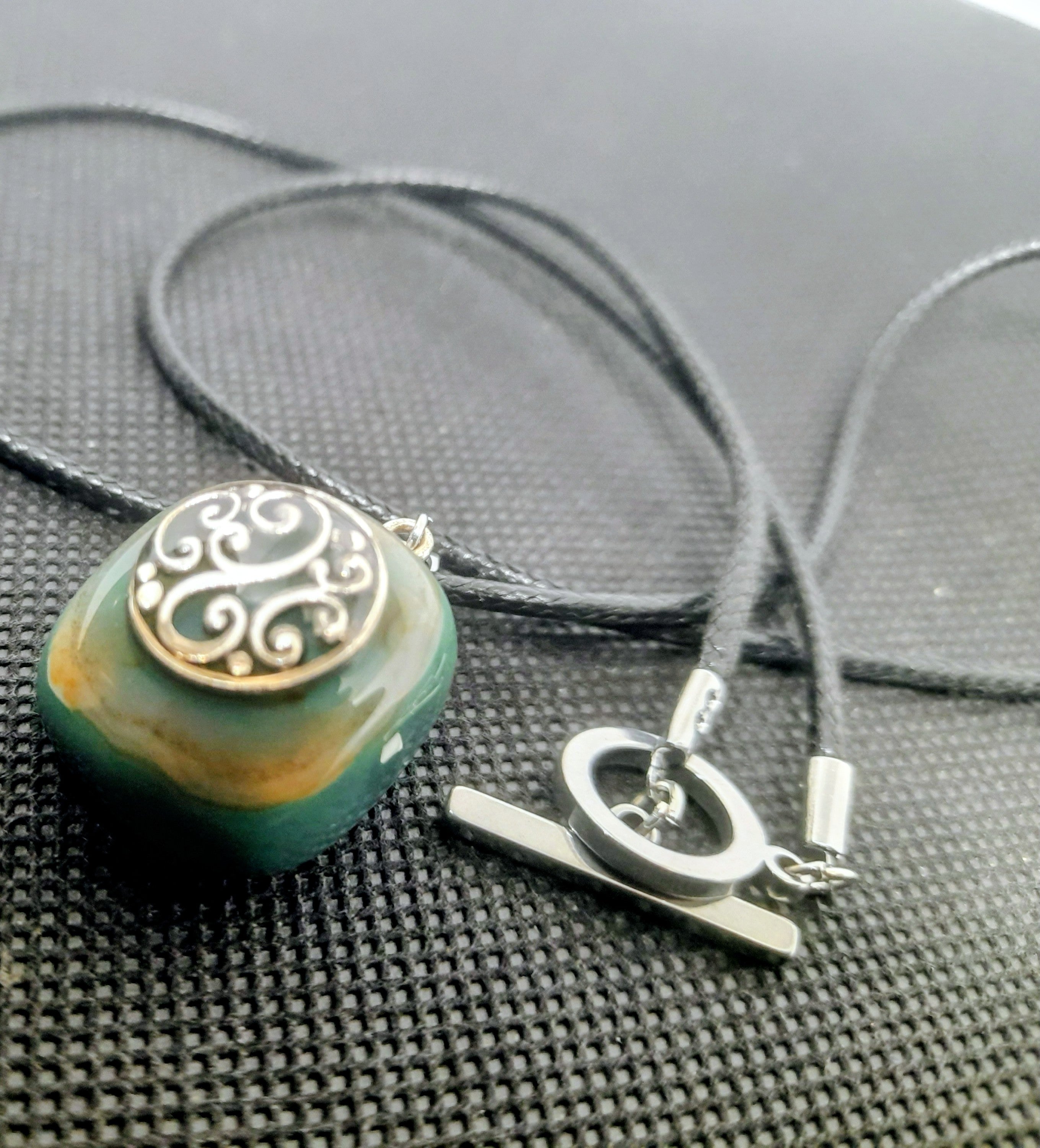 Handmade Irish Green Stone Pendant – Celtic Swirl Design | Black Cord